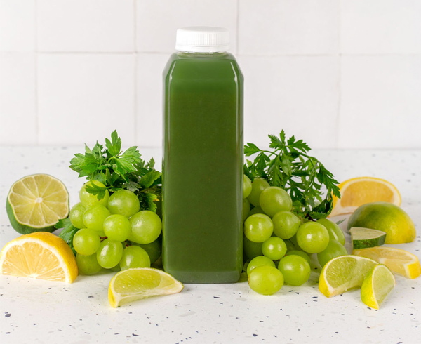 16 oz cold pressed juice bottle filled with green juice